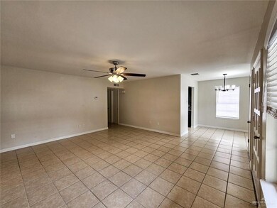 Unfurnished room with a chandelier, light tile patterned flooring, a ceiling fan, and baseboards
