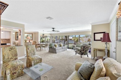 Living room with carpet, ornamental molding, a tex