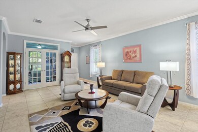 Living room with ornamental molding, ceiling fan, 