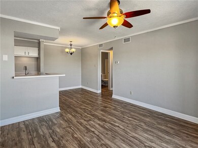 Unfurnished living room featuring a textured ceili