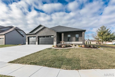 View of front of house with a garage and a front yard
