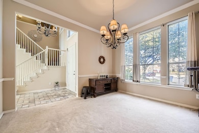 Living room featuring ornamental molding, a tiled 