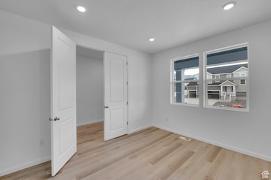 Office with light wood-style flooring, baseboards, and recessed lighting