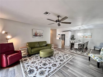 Living room featuring light wood-style flooring and a ceiling fan
