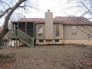 View of the back of the home and the screened, cov