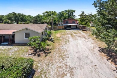 Main House & Garage, Concrete pad parking ( carport roof was removed) & lots of extra parking. Upstairs mother in law Apartment seen above garage.