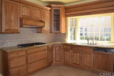 Tiled backsplash, newer sink, stovetop and beautif