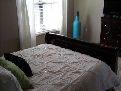 Spacious master bedroom with large double window f