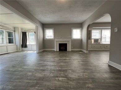 Unfurnished living room featuring a textured ceiling, cooling unit, and dark hardwood / wood-style flooring