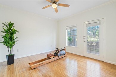 Workout area featuring ornamental molding, wood-t