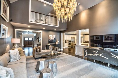 The impressive family room with a dramatic vaulted ceiling, large bespoke mirror and full length curtains that stay with the home.