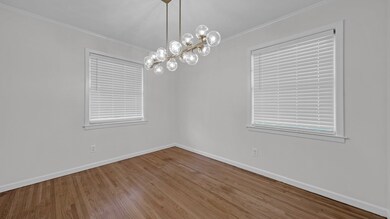 Empty room with a chandelier, crown molding, plent