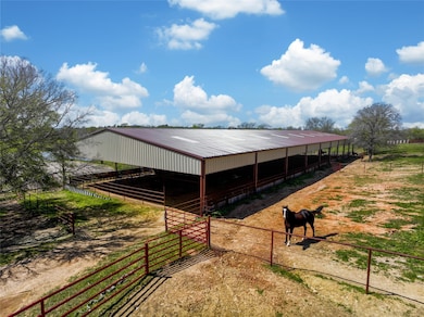 Spacious covered arena with ample outdoor space, p