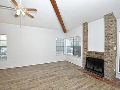 Unfurnished living room featuring a brick firepla
