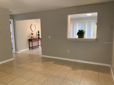 A large opening leads to the kitchen, the door on 