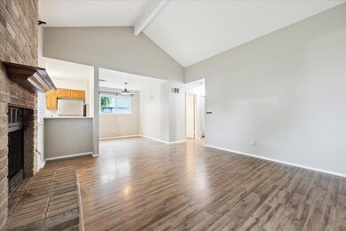 Unfurnished living room featuring a brick firepla