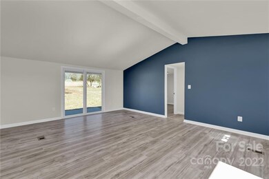 Sliding glass doors with privacy blinds in-between the glass lead to a patio and the back yard 