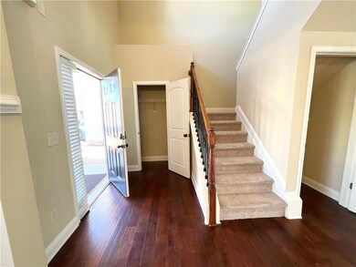 Entrance foyer featuring hardwood / wood-style flooring and stairs