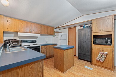 Kitchen featuring range with electric stovetop, b