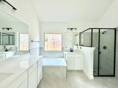 Full bathroom featuring two vanities, a shower st