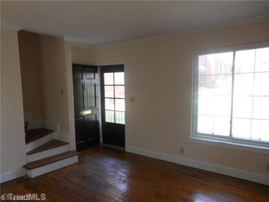 Living Room. Freshly painted unit with all hardwood flooring and replacement windows.