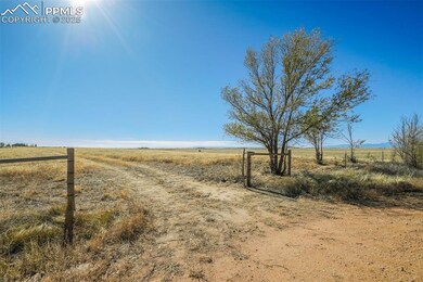 View of dirt / gravel road featuring a view of rural / pastoral area