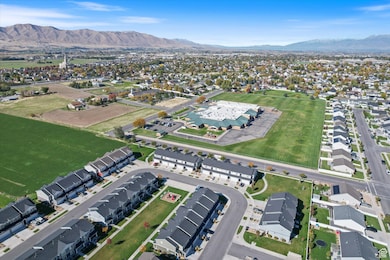 Aerial overview of property's location featuring nearby suburban area and a mountainous background