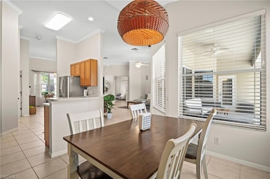 Dining room with a ceiling fan, light tile pattern