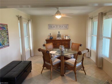 Dining room featuring crown molding, light tile patterned floors, and a ceiling fan