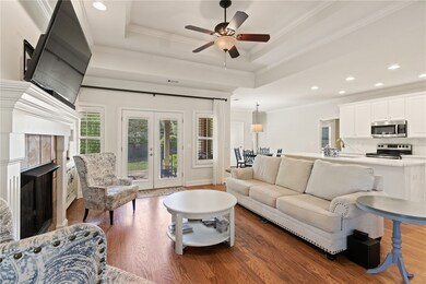 The living room is bright and open. A gas fireplac