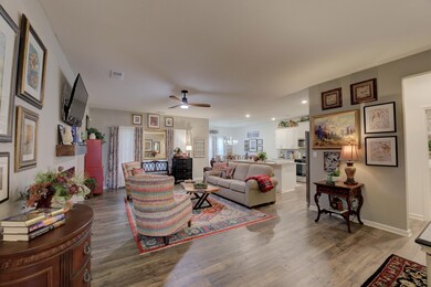 Great room featuring ceiling fan, hardwood floorin