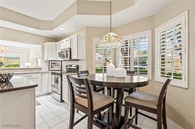 Tiled dining area featuring a chandelier, a wealth