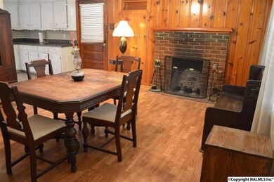 14 x 16 dining room has a wood burning fireplace.  The antique furniture is for sale. Please make an offer.