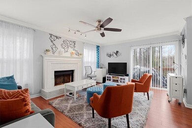 Living room featuring crown molding, ceiling fan, 
