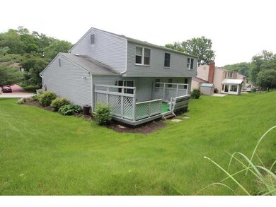 Exterior Back. Lush landscaping surrounds the deck