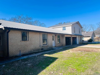Front of property with a garage and a front yard