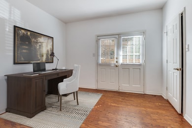 Home office featuring wood finished floors and baseboards