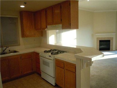 Kitchen with gas stove/oven and tile floor.