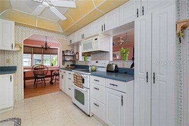 Kitchen has ample updated cabinetry, pantry, ceiling fan, tiled flooring and 2 pass throughs to the Living room.