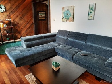 Living room featuring wood walls and hardwood / wood-style floors