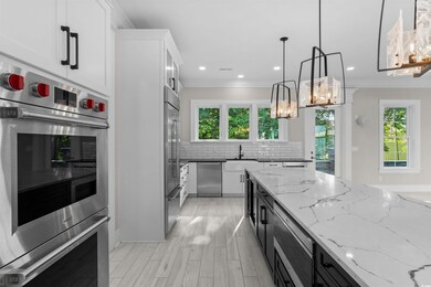 Kitchen with crown molding, a chandelier, built in