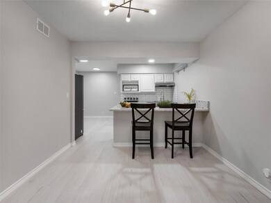 Kitchen featuring kitchen peninsula, tasteful back