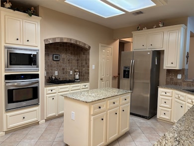 Spacious kitchen featuring granite countertops, st