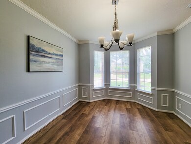 Formal dining. Note the Bay window, crown & chair