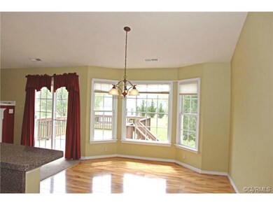 Dining area has a great chandelier and bay windows