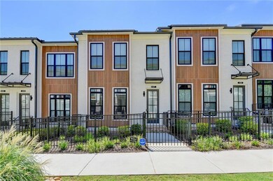 View of front of property featuring a fenced front yard and brick siding