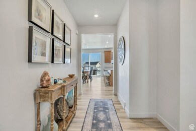 Corridor featuring light wood-type flooring and recessed lighting