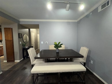 Dining area featuring ornamental molding, dark har