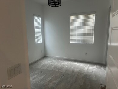 Empty room featuring carpet flooring, baseboards,