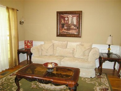 The formal dining room which is being used a formal living has chair rail, picture framing, high ceiling and crown molding.